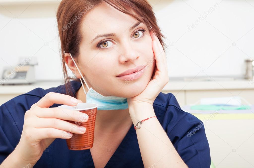 Beautiful female or woman doctor having a coffee break