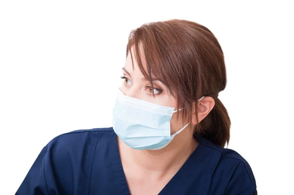 Woman doctor looking left and wearing mask — Stok fotoğraf