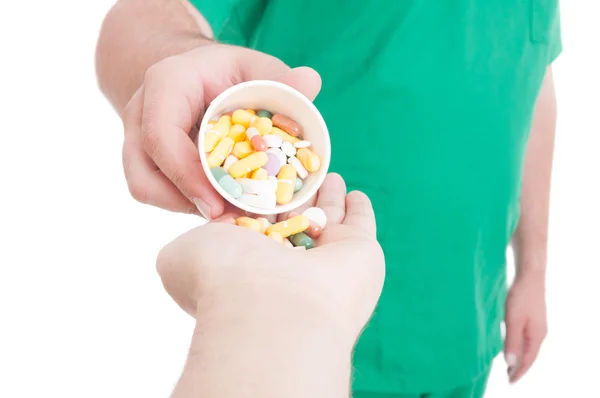 Doctor, medic or pharmacist giving pills in patient hand — Stock Photo, Image