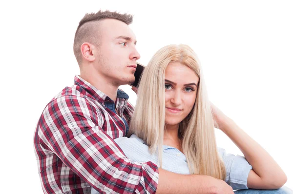 Hombre abrazando a la mujer y hablando por teléfono con otro — Foto de Stock