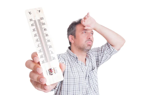 Sumer heat and heatwave concept with man holding thermometer — Stock Photo, Image