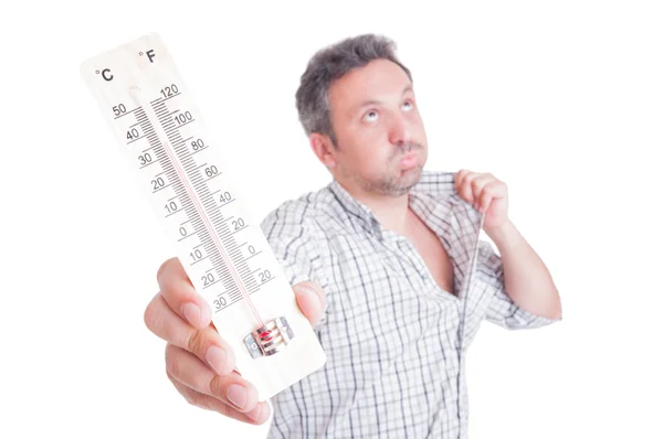 Sweaty man holding thermometer as summer heat concept — Stock Photo, Image