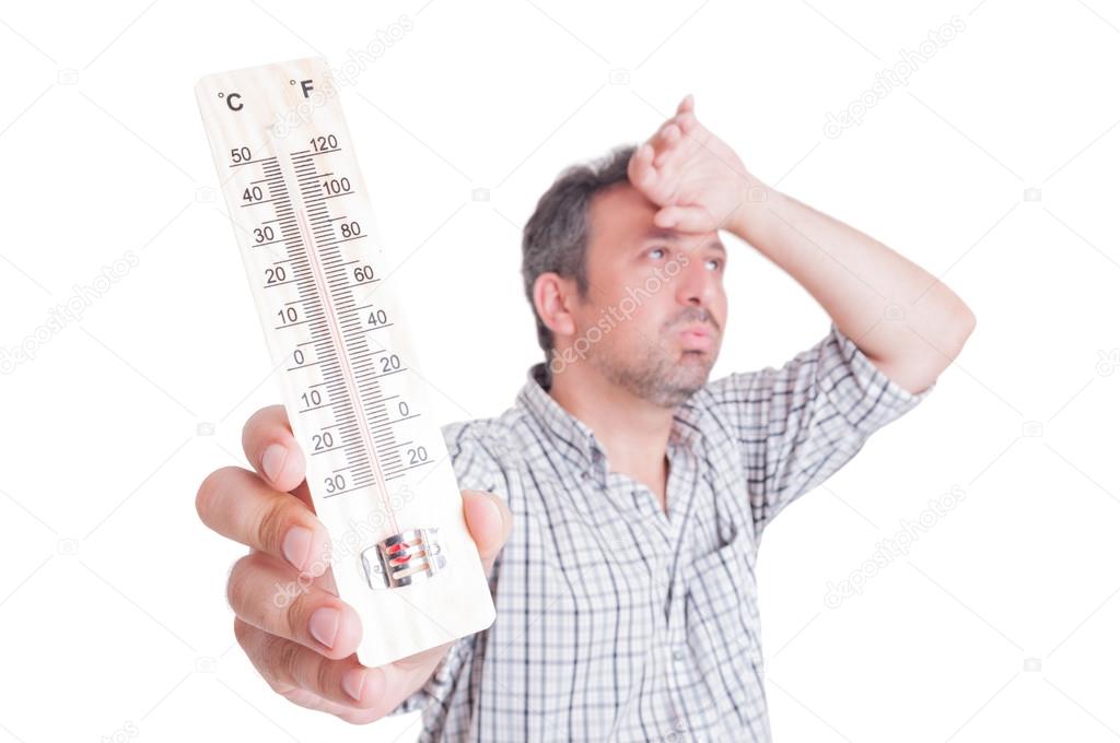 Sumer heat and heatwave concept with man holding thermometer