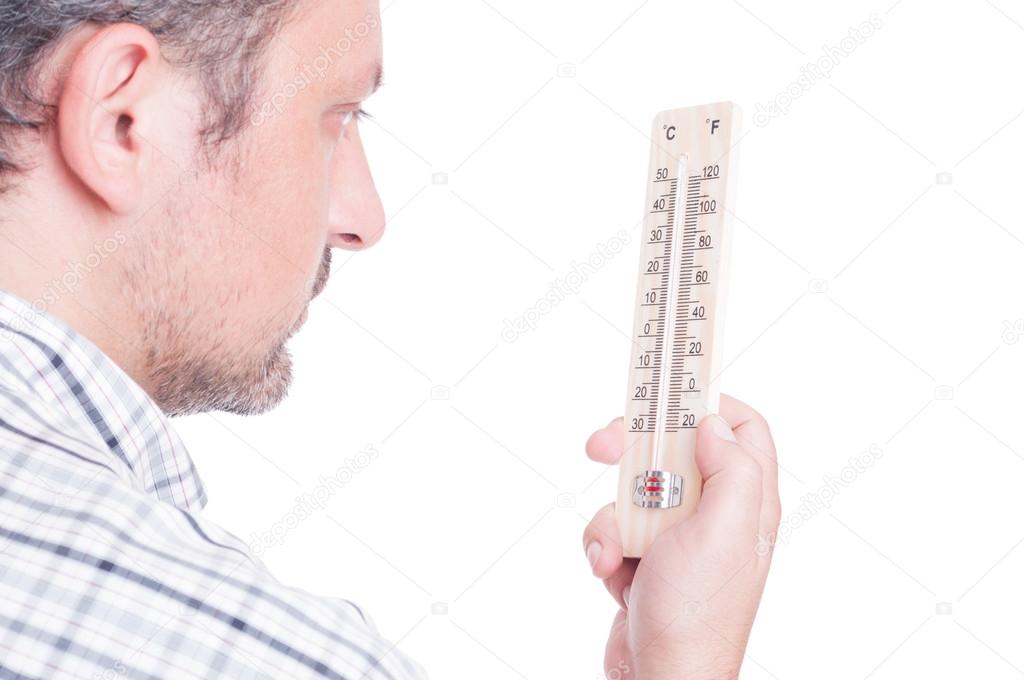 Man holding thermometer and checking temperature