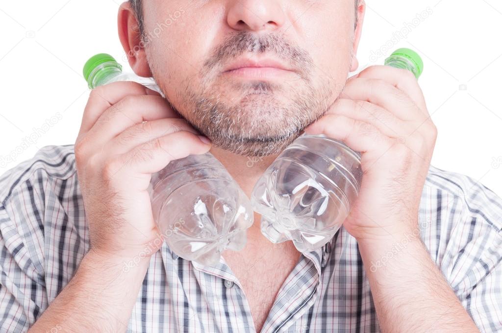 Man cooling his neck using cold water plastic bottles