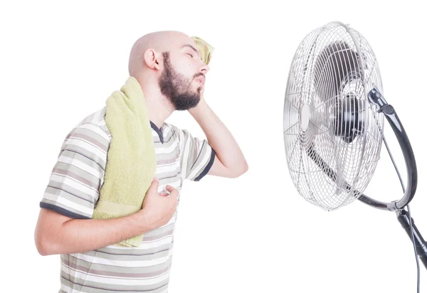 Heated man wiping sweat in front of cooler — Stock Photo, Image