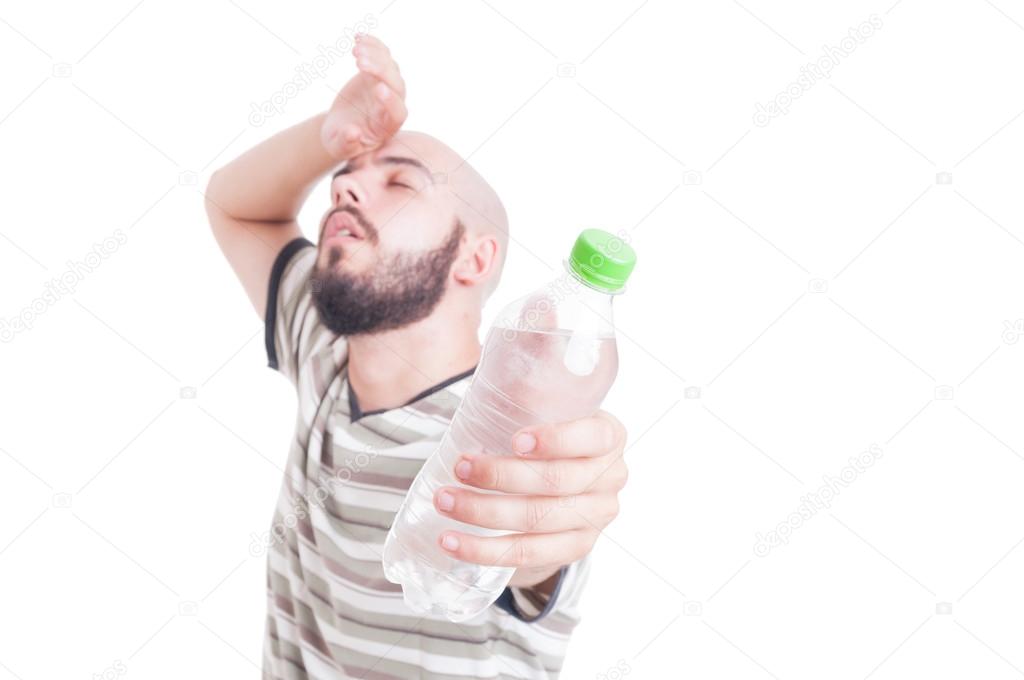 Sweaty man holding a bottle of cold water