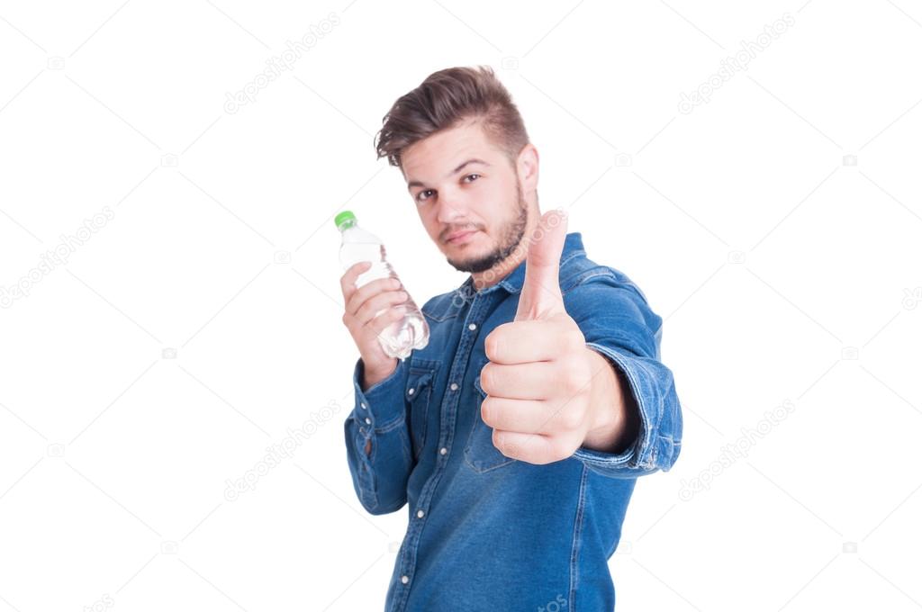 Confident man holding water and showing like