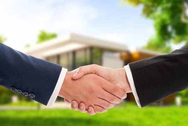 Handshake on house outdoor background — Stock Photo, Image