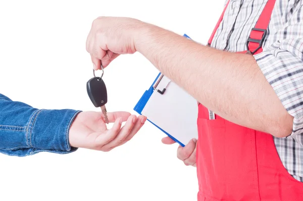 Mechanic handing car key to customer or client hand — Stock Photo, Image