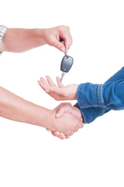Mechanic or car dealer handing key to customer with handshake — Stock Photo, Image