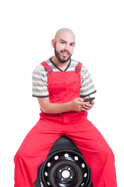 Lachende mechanic texting — Stockfoto