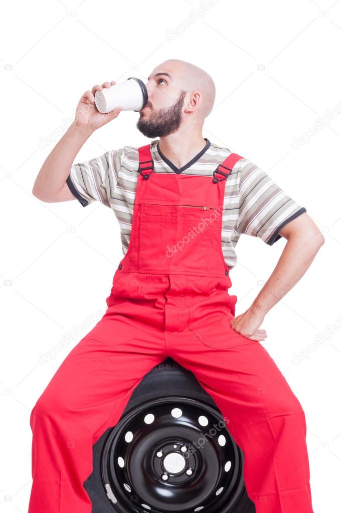 Mechanic taking a break and drinking coffee