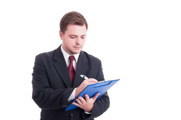 Busy accountant writing on clipboard — Stock Photo, Image
