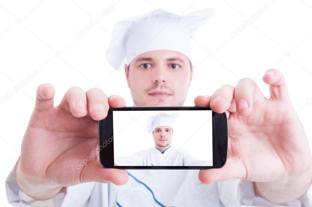 Chef or cook taking selfie with back phone camera