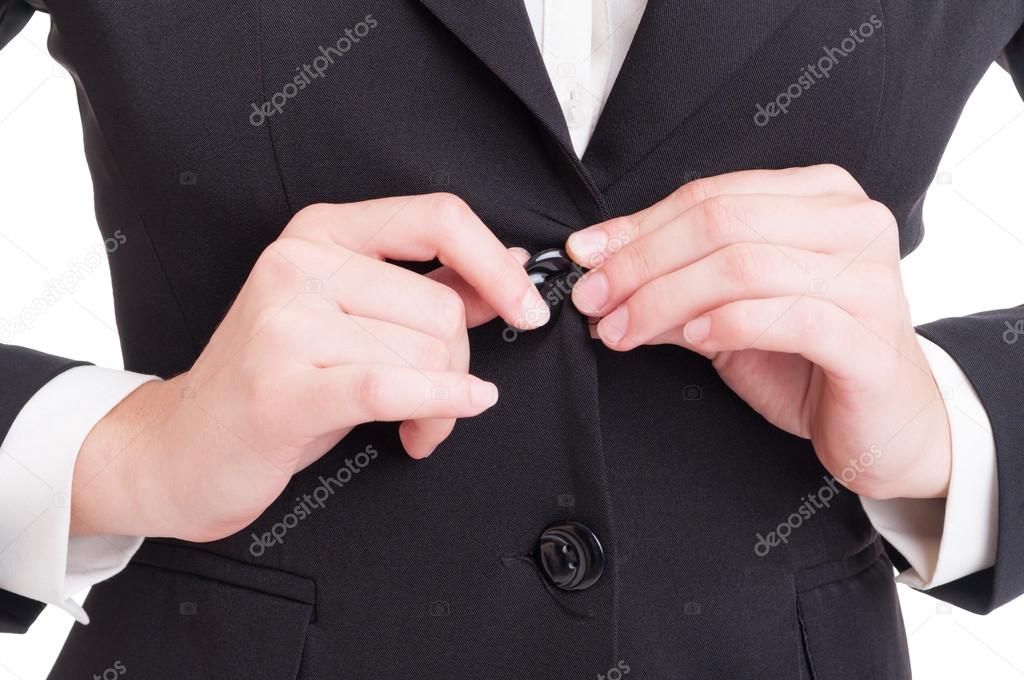 Closeup with business woman hands closing suit jacket button