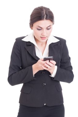 Concentrated young business woman texting on smartphone