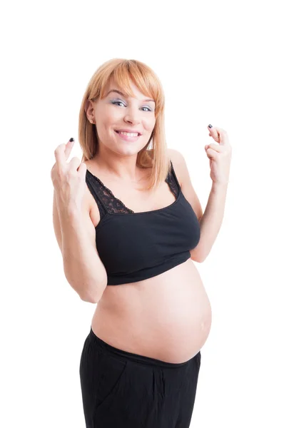 Unga gravid kvinna visar lycka symbol korsning fingrar — Stockfoto