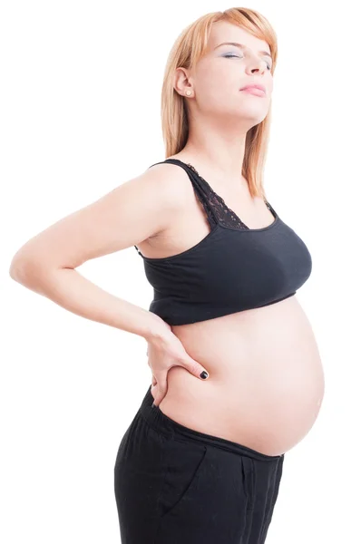 Pregnant woman sufering lower back or lumbar area pain Stock Image