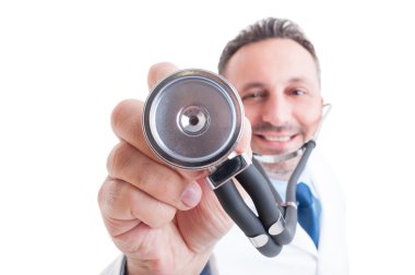 Medic or doctor holding stethoscope with focus on it