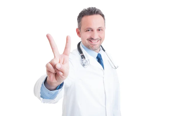 Handsome  doctor or medic showing peace and victory gesture — Stock Photo, Image