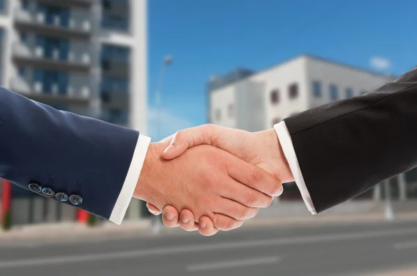 Real estate handshake over new buildings background — Stock Photo, Image