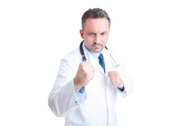 Handsome medic or doctor showing fists and threatening