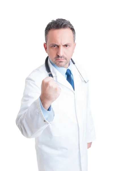 Young medic or doctor showing fist and threatening — Stok fotoğraf