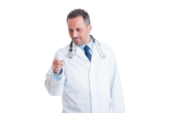 Friendly pediatrician playing with soap bubble — Stock Photo, Image