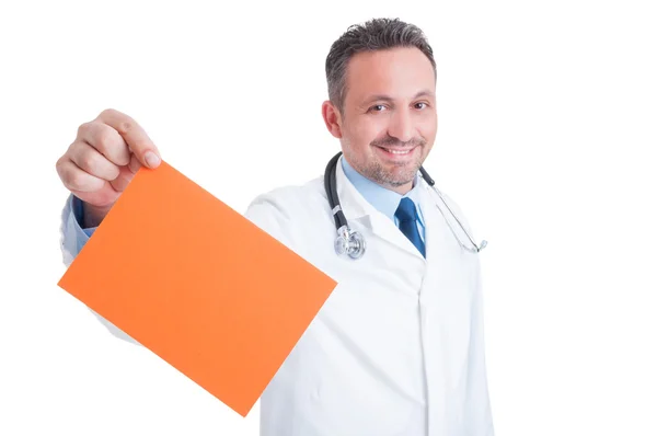 Doctor or medic holding orange blank paper with copy space — Stock Photo, Image