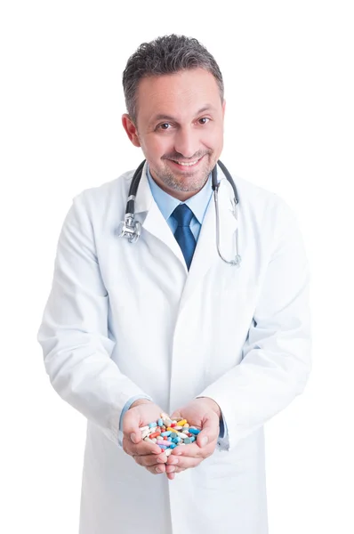 Doctor or medic holding both palms full of pills — Stock Photo, Image