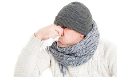 Cold man blowing his nose on paper napkin or hanky clipart