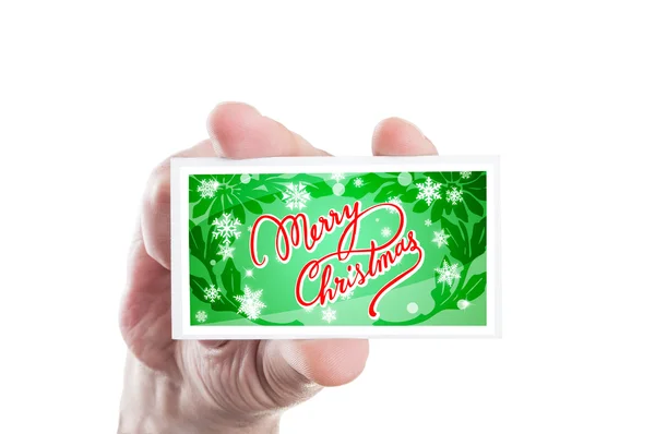 Hand holding merry Christmas green greeting — Stock Photo, Image