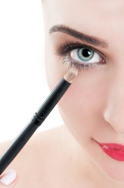 Kadın uygulamak göz makyaj fırça kullanarak