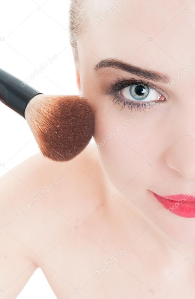 Close-up with woman using make-up brush