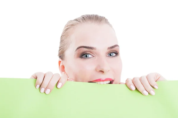 Beautiful cosmetics model holding and biting green cardboard — Stock Photo, Image