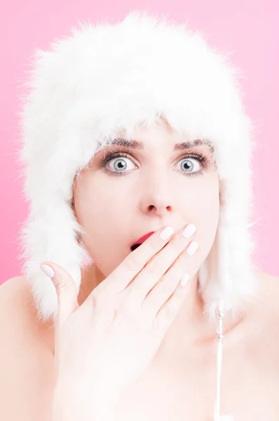 Astonished young woman wearing a white fur hat — Stock Photo, Image