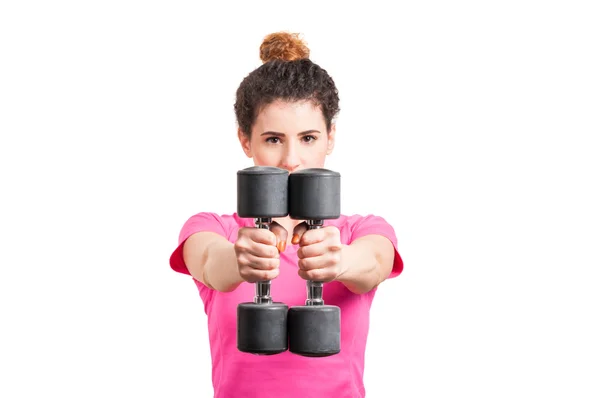 Close-up of fit, young woman extending her arms with dumbbells — Stock Photo, Image