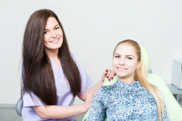 Aantrekkelijke tandarts vrouw en mooie vrouwelijke patiënt — Stockfoto