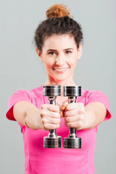 Sporty female doing arms exercises with dumbbells — Stock Photo, Image