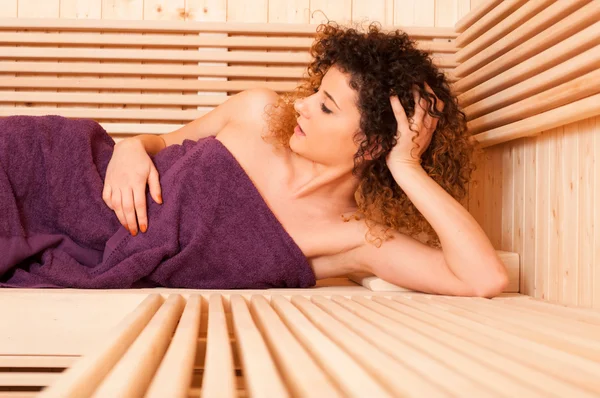 Closeup of attractive woman lying relaxed at sauna — Stock Photo, Image