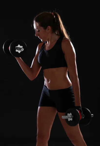 Young woman doing exercise with dumbbells — Stock Photo, Image