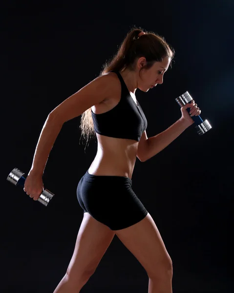 Jeune femme faisant de l'exercice avec des haltères — Photo