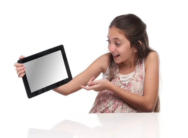 Beautiful pre-teen girl with a tablet computer. — Stock Photo, Image