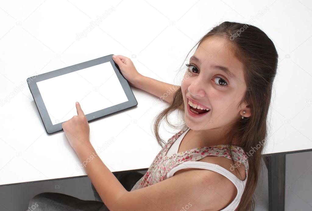 Beautiful pre-teen girl with a tablet computer.