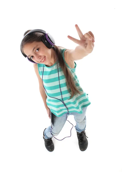 High angle picture for a beautiful pre-teen girl using a tablet computer and headphones. — Stock Photo, Image