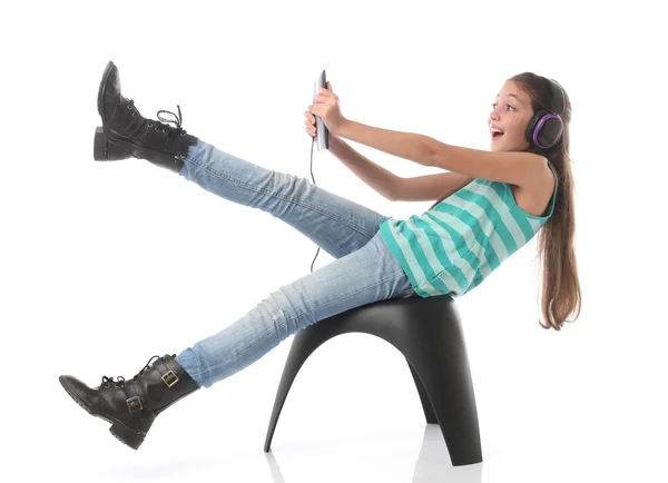 Beautiful pre-teen girl going crazy with a tablet computer — Stock Photo, Image