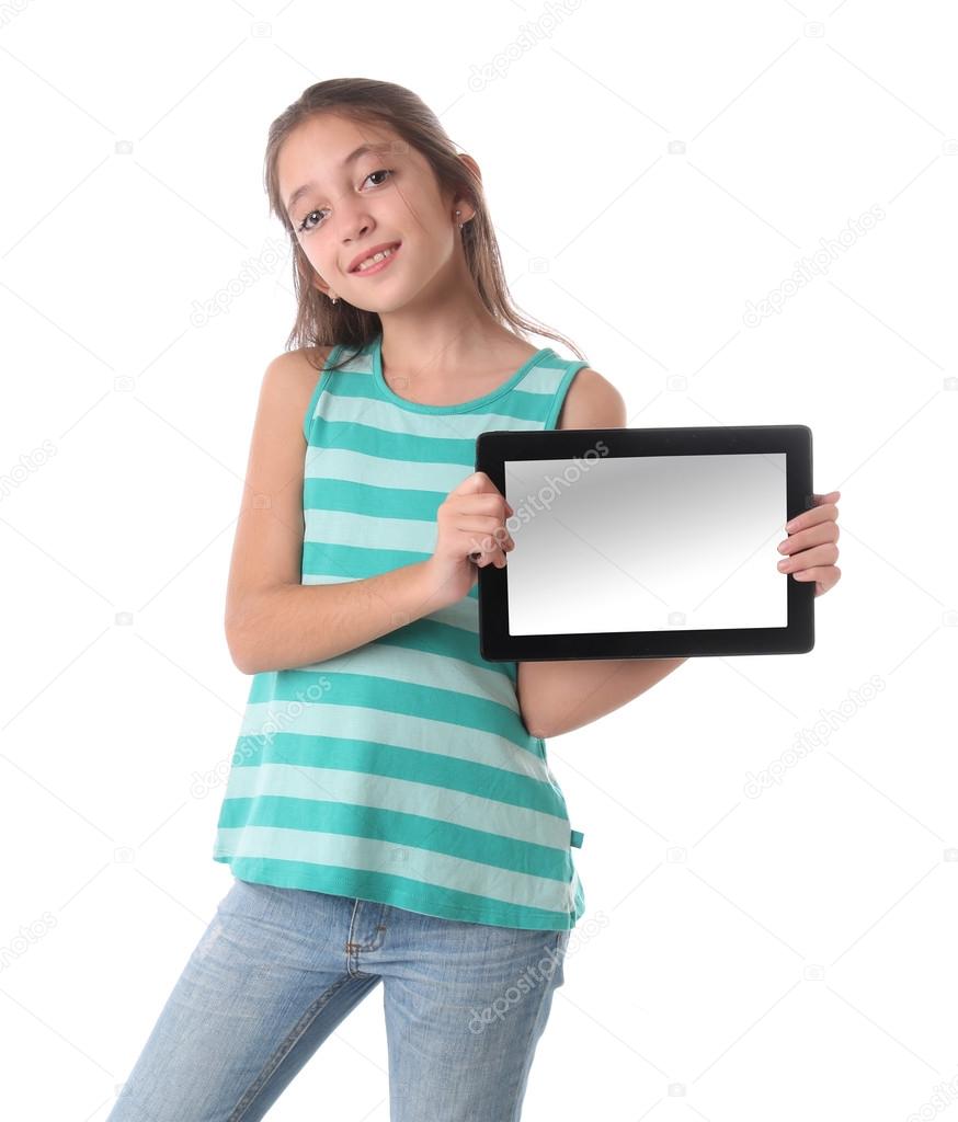 Beautiful pre-teen girl with a tablet computer. Isolated