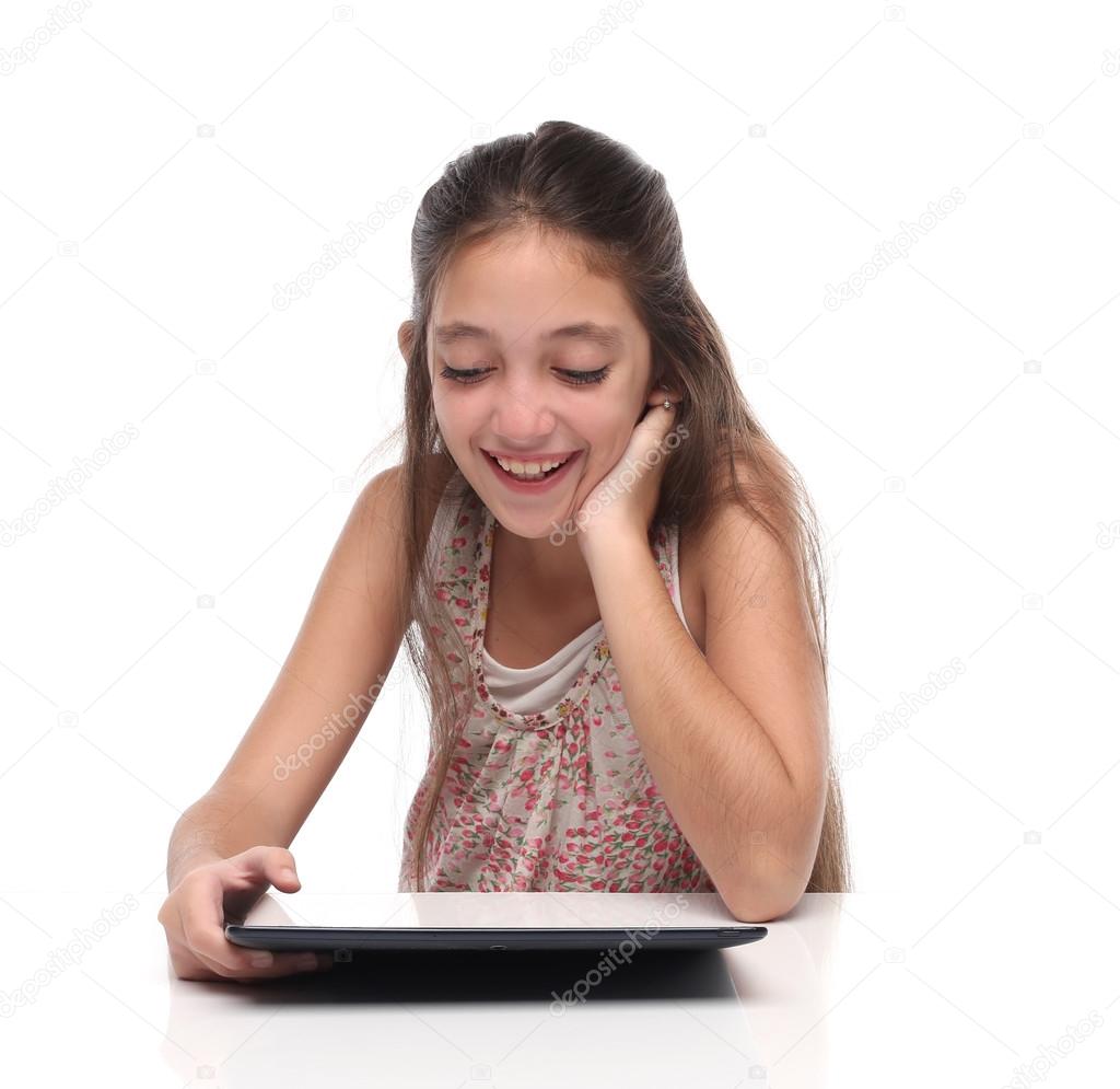 Beautiful pre teen girl with a tablet computer.