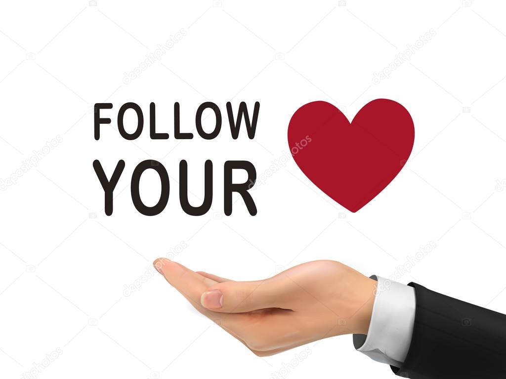 follow your heart words holding by realistic hand